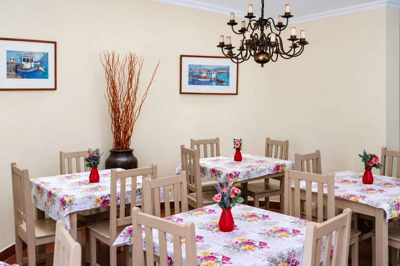 A dining table and white chairs in the Cambridge House dining room