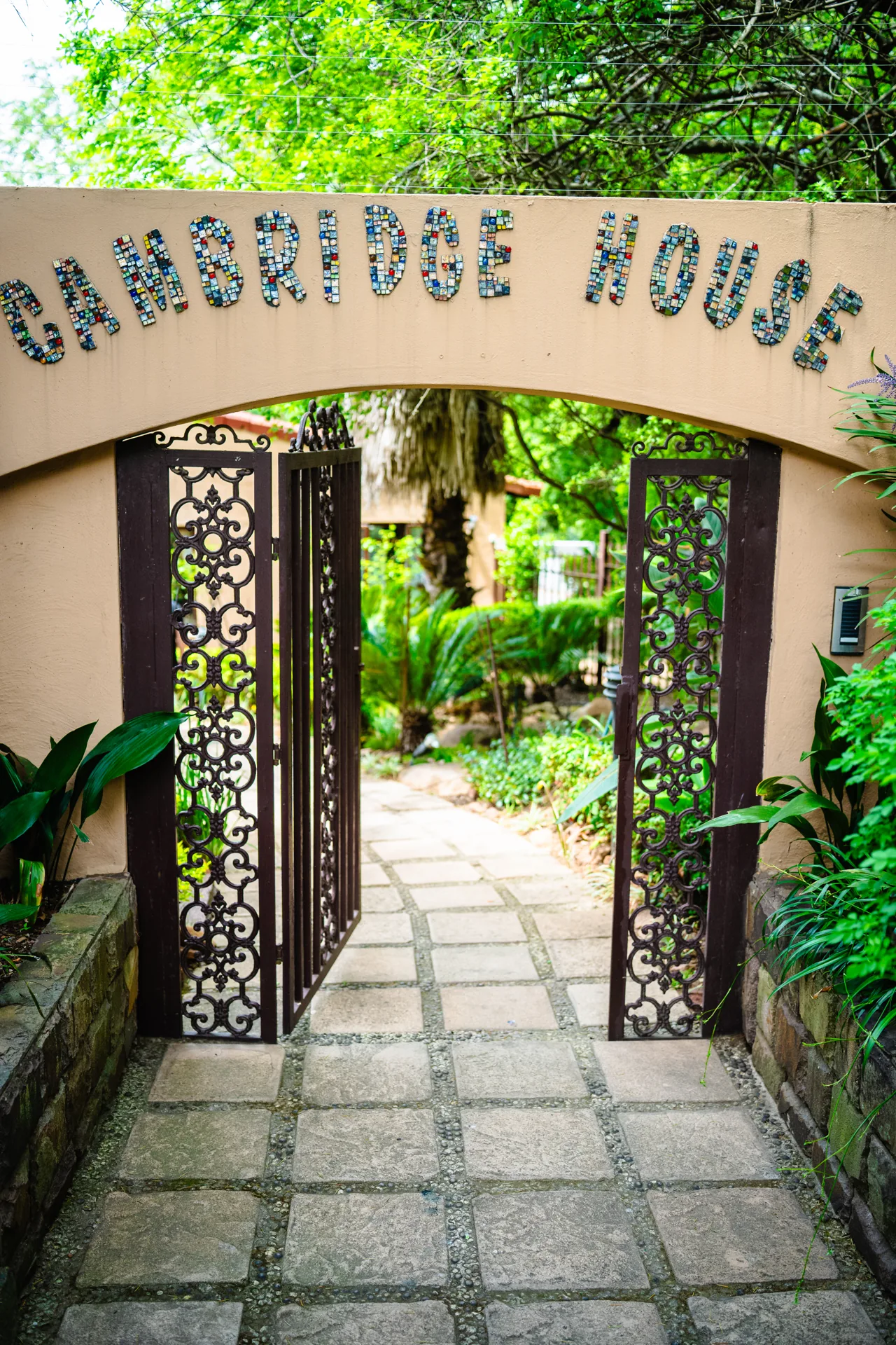 Cambridge House sign above the entrance gate and garden walkway